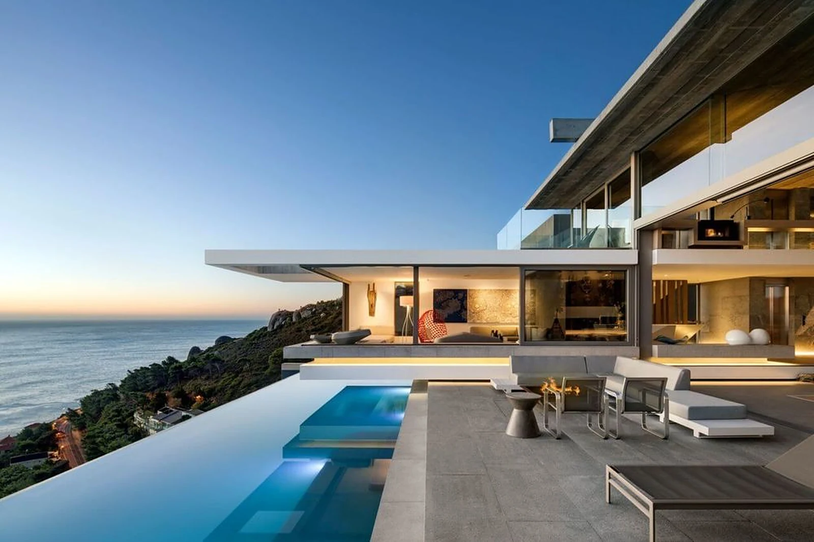 Cliffside private villa in Cape Town with an infinity pool and terrace overlooking the Atlantic at dusk