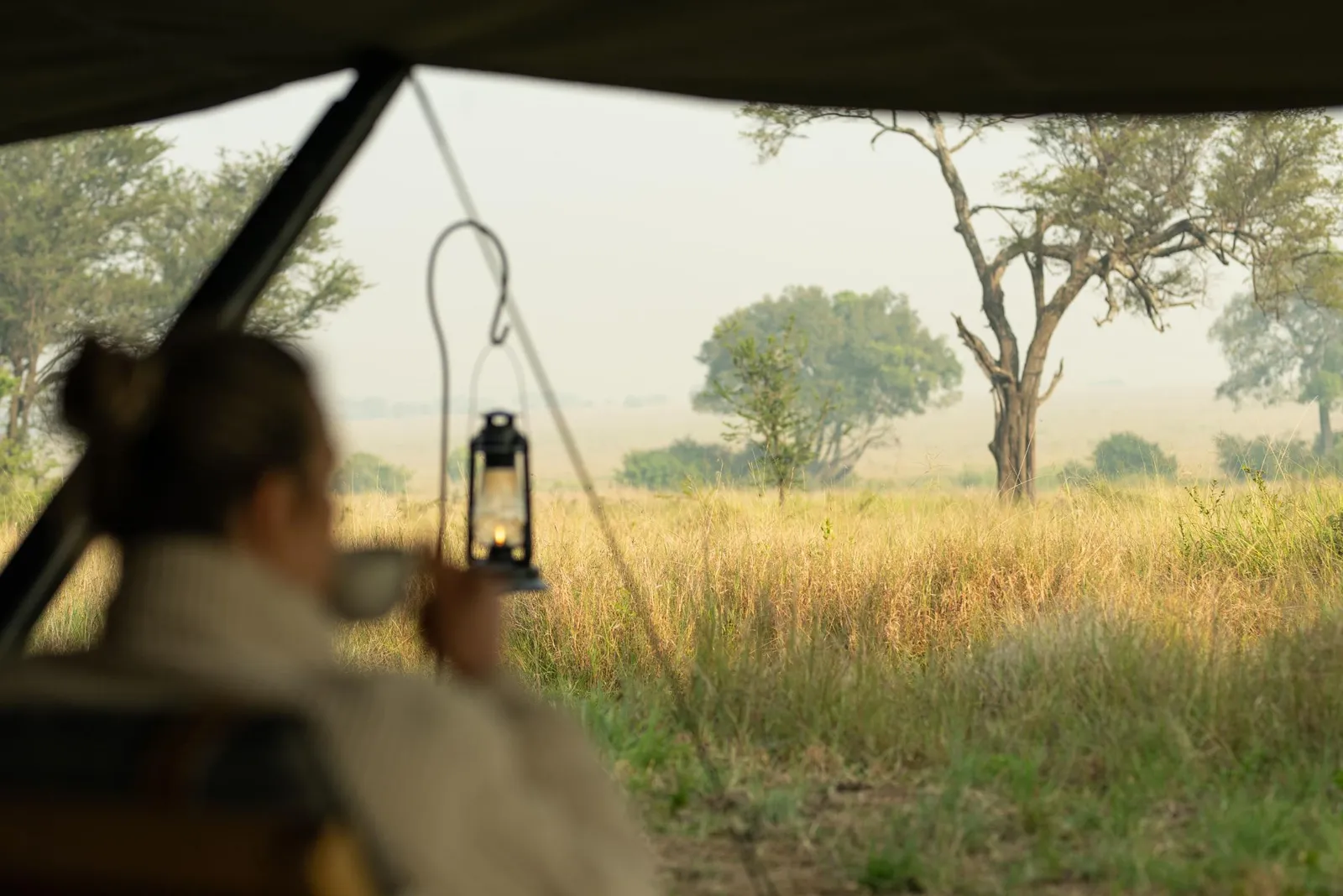 Morning coffee by lantern light at a tented camp in Kenya