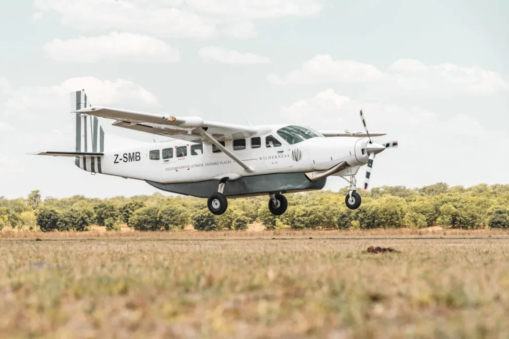 Light aircraft landing at a bush airstrip in Zimbabwe